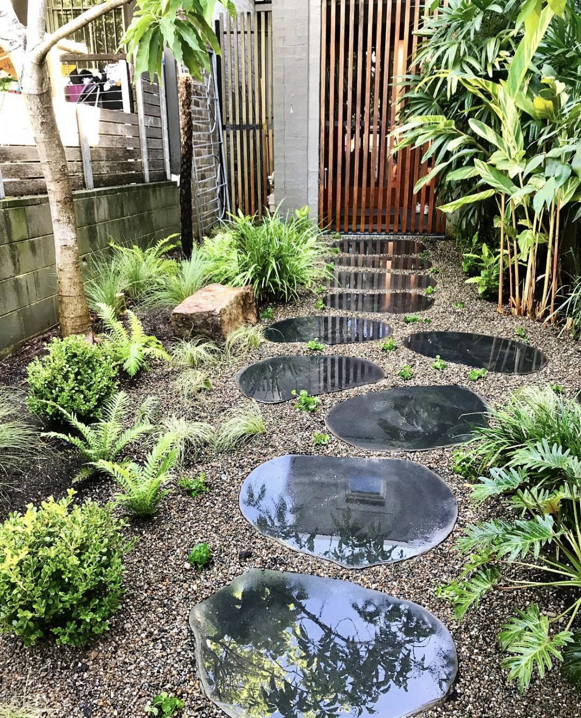 Stepping stones set through a soft planted garden bed
