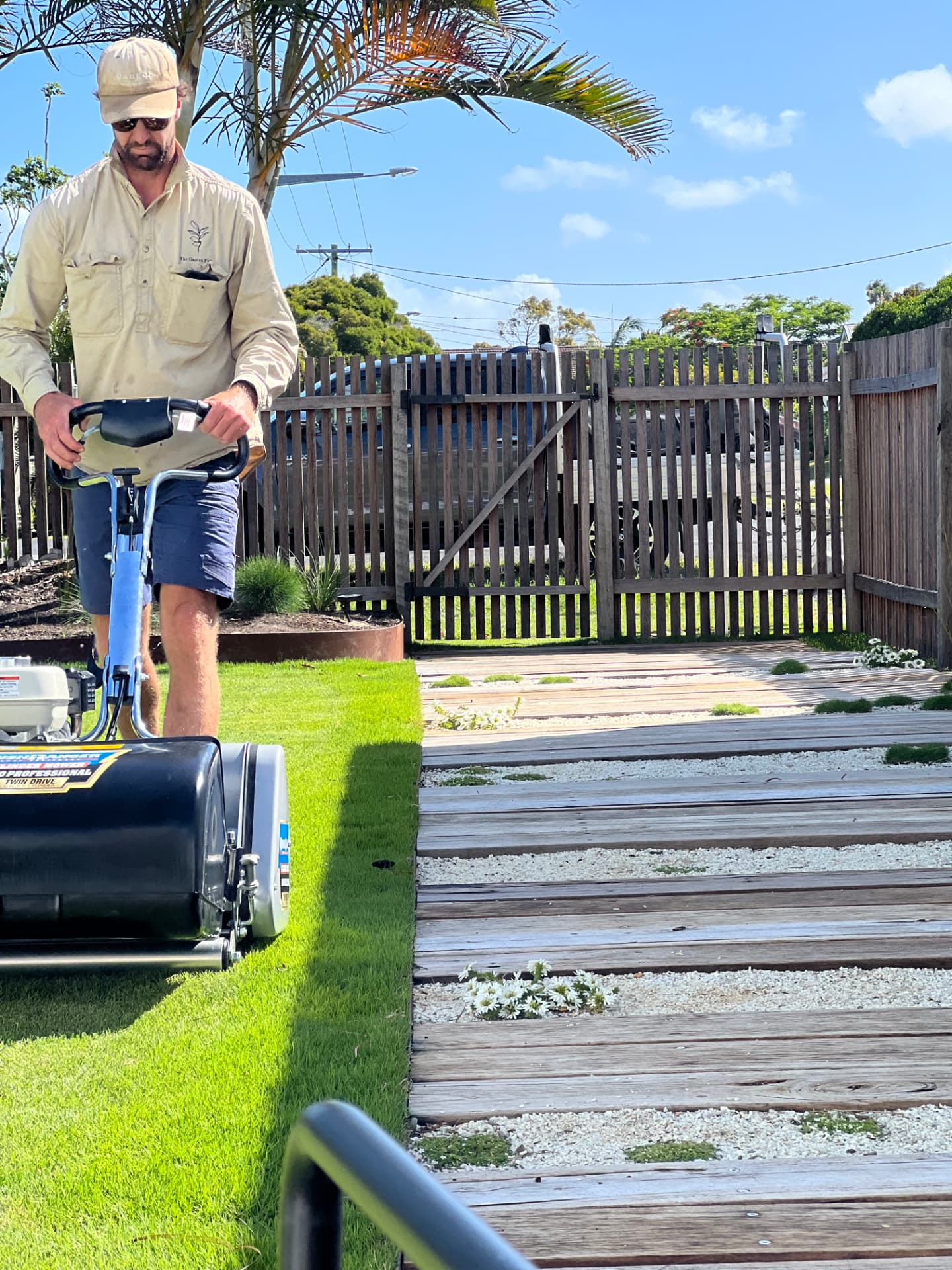 The Garden Folk team mowing a Northern Rivers lawn